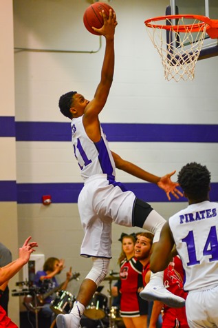 Jalen Taylor went high for a layup during the second quarter. (Photo by Brian Turrel)	