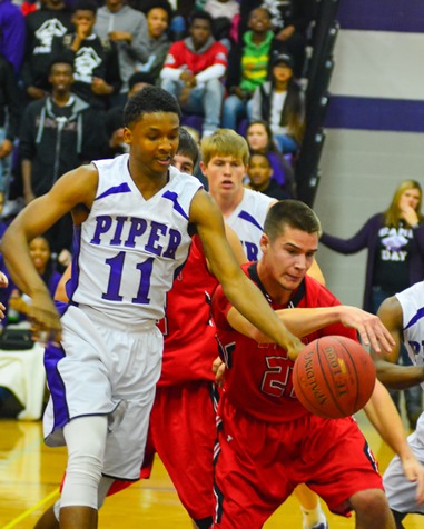 Jalen Taylor outran Ottawa senior Cooper Diel for a loose ball in the third quarter. (Photo by Brian Turrel)	